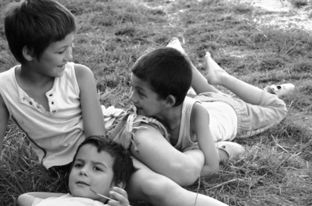 50628248 - detail of a group of children on the grass in the assembly reminiscent of renaissance paintings - retro styled black and white photo